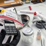 Forensic lab, forensic police take mobile from murder victim's evidence bag, conceptual image